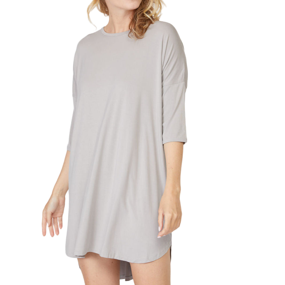 A woman wearing a thigh-length gray 3/4 sleeve bamboo viscose nightshirt with a crew neckline.