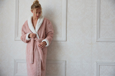 model wearing pink sherpa bathrobe