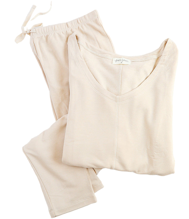 Beige pajama set with a top and pants on a white background